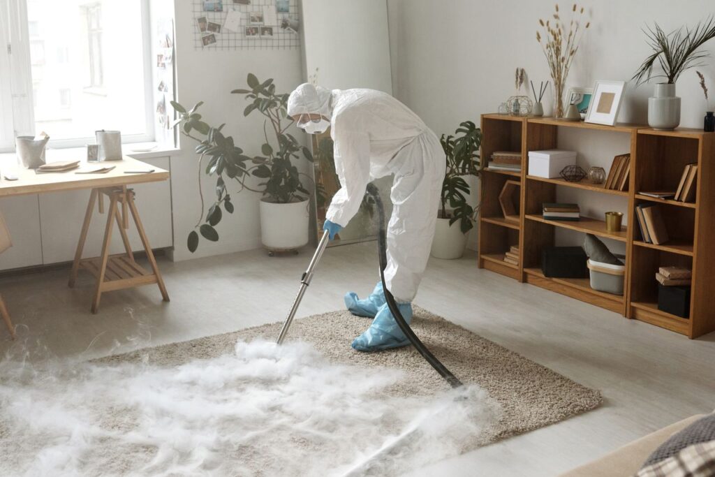 Crafting Captivating Headlines: Your awesome post title goes here A woman in protective gear disinfects a carpet indoors to ensure safety during the COVID-19 pandemic.